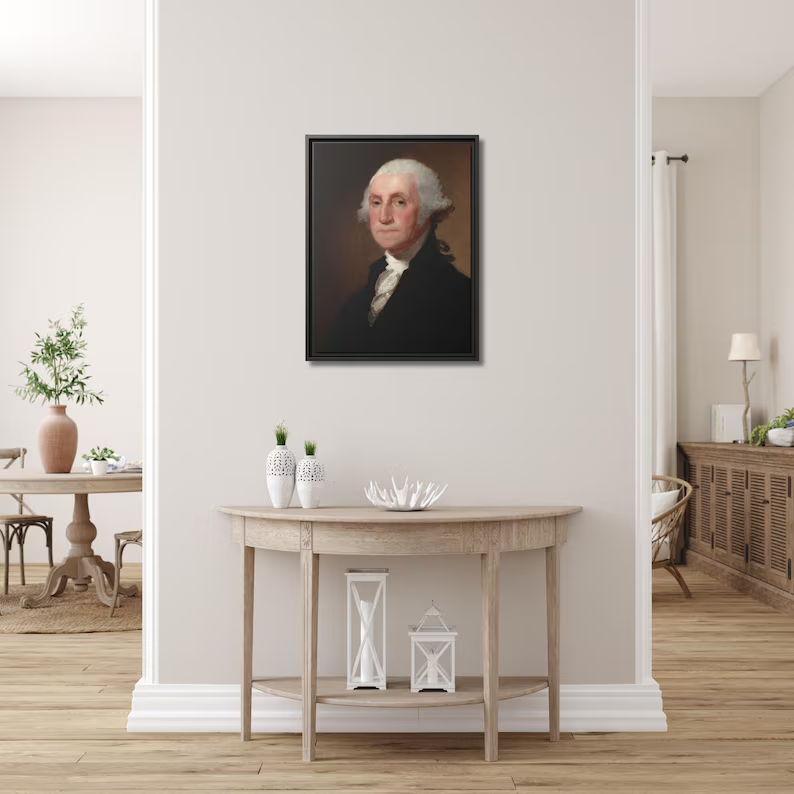 Athenaeum Portrait of George Washington framed canvas hung above a demi-lune console table in a bright airy entryway