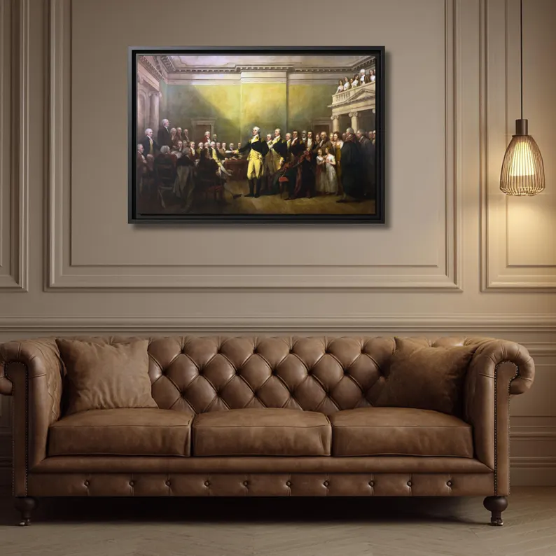 General George Washington Resigning His Commission framed canvas above a cognac leather Chesterfield sofa in a paneled study