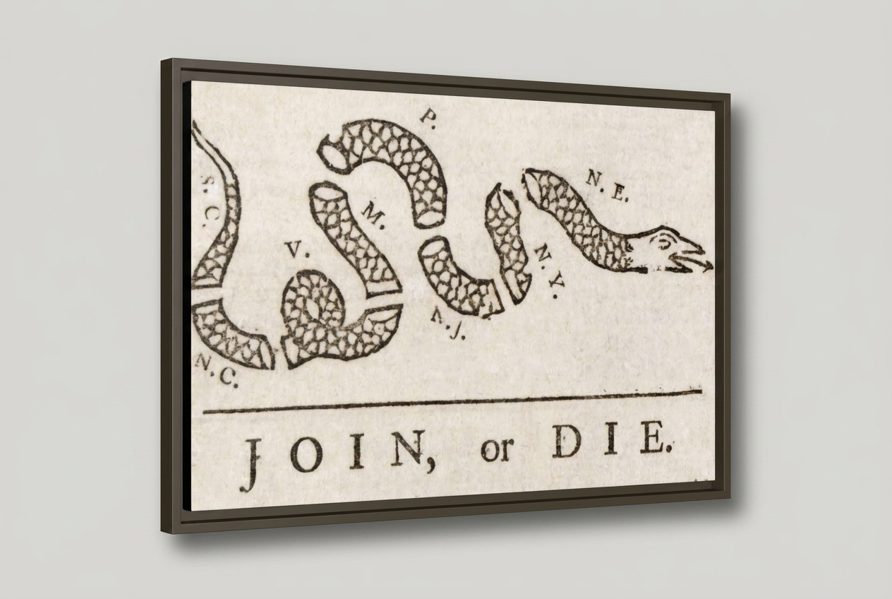 Three-quarter angled studio view of the Join, or Die floating frame canvas showing black frame depth and reveal gap on a light gray background