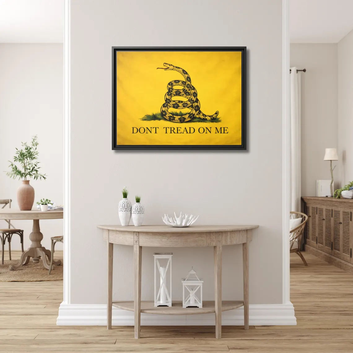 Gadsden Flag 'Don't Tread on Me' framed canvas above a light demi-lune console table in a bright airy entryway
