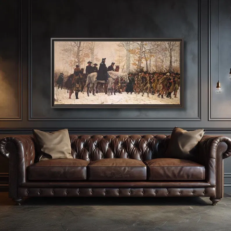 Valley Forge March panoramic framed canvas hung above a tufted brown leather Chesterfield sofa against a dark paneled wall